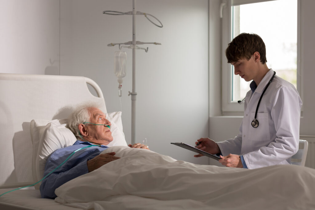 Young doctor talking with patient